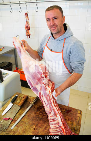 Butcher, Mishtore Cana, in his shop in Gjakove, Kosovo. Stock Photo