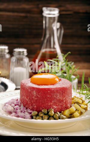Beef tatare with egg, onion, cucumber and capers Stock Photo