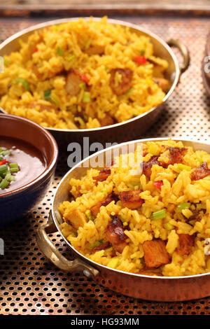 Chicken with basmati rice fried in stainless pan Stock Photo