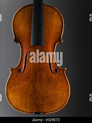 Stringed Musical Instrument, a violin on a white - grey background. Stock Photo