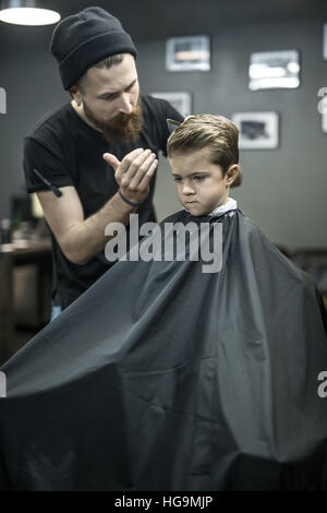 Kid's hair styling in barbershop Stock Photo