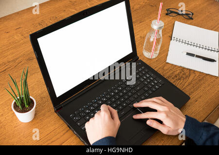 Man using his laptop with white screen Stock Photo