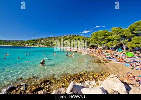 MURTER, CROATIA - AUGUST 17: Unidentified people enjoying summer holldays on crystal clear turquoise beach in Croatia, Island of Murter, Dalmatia regi Stock Photo