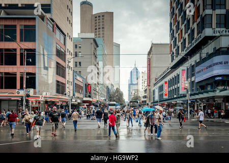 Melbourne, Australia - December 27, 2016: People crossing the intersection of Elizabeth and Flinders street in Melbourne City Business District Stock Photo