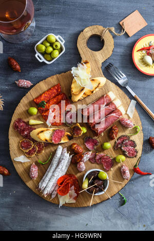 Different spanish embutidos on a table: jamon, chorizo, salami, cheese and wine. Top view Stock Photo