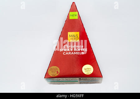 Box of M&S Christmas sticky toffee caramels isolated on white background - for other side of box see image HGH7B9 Stock Photo