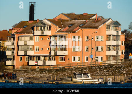 Karlskrona, Sweden - January 5, 2017: Documentary of urban lifestyle. Apartment building on a cold morning. Marina visible in foreground. Very light s Stock Photo