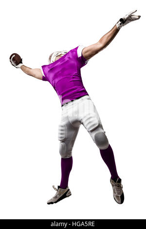 Football Player with a pink uniform making a catching on a white background. Stock Photo