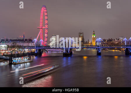 London, UK - December 13, 2016: London skyline at night withembankment bridge, big ben and houses of parliament at the background, as see Stock Photo