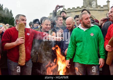 Haxey, Lincolnshire, UK. 6th Jan, 2017. The Haxey Hood is a 700-year old game, it took place today during a downpour. The Haxey fool is paraded around three pubs, singing chants and drinking free ale, burning of straw near village church behind the fool, then men and children do battle on a near by field.Smoking of the fool. © Ian Francis/Alamy Live News Stock Photo