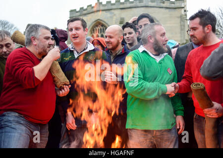 Haxey, Lincolnshire, UK. 6th Jan, 2017. The Haxey Hood is a 700-year old game, it took place today during a downpour. The Haxey fool is paraded around three pubs, singing chants and drinking free ale, burning of straw near village church behind the fool, then men and children do battle on a near by field. © Ian Francis/Alamy Live News Stock Photo