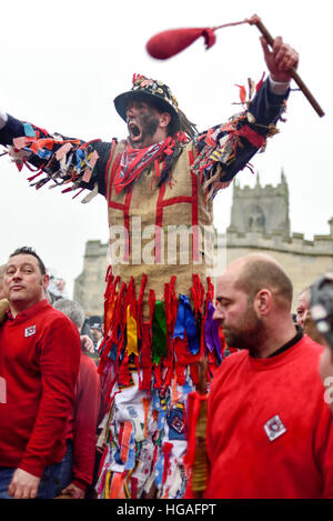 Haxey, Lincolnshire, UK. 6th Jan, 2017. The Haxey Hood is a 700-year old game, it took place today during a downpour. The Haxey fool is paraded around three pubs, singing chants and drinking free ale, burning of straw near village church behind the fool, then men and children do battle on a near by field. © Ian Francis/Alamy Live News Stock Photo