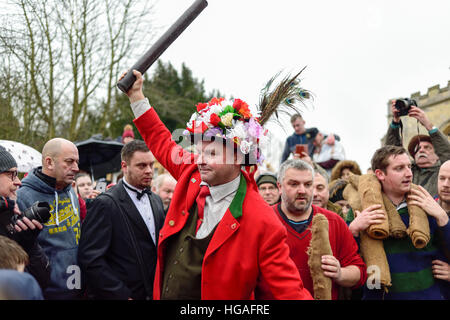 Haxey, Lincolnshire, UK. 6th Jan, 2017. The Haxey Hood is a 700-year old game, it took place today during a downpour. The Haxey fool is paraded around three pubs, singing chants and drinking free ale, burning of straw near village church behind the fool, then men and children do battle on a near by field.Lord of the Hood. © Ian Francis/Alamy Live News Stock Photo