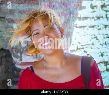 Closeup portrait of a beautiful, redhead Filipino woman with hair blowing in the wind. Philippines. Stock Photo