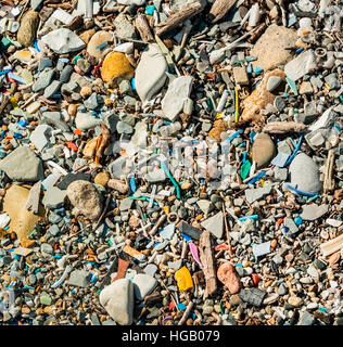 a lot of small plastic trash on the beach Stock Photo