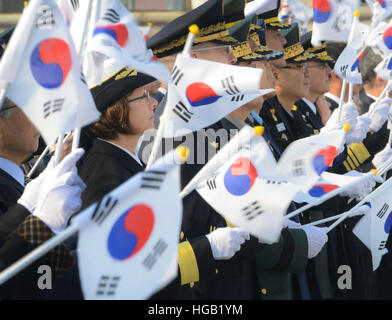 Military leadership wave the national flag of the Republic of Korea during a memorial ceremony. Stock Photo