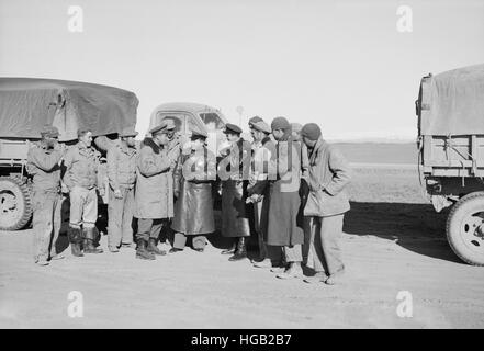 Russian officers in black leather coats surrounded by a group of American soldiers, 1943. Stock Photo
