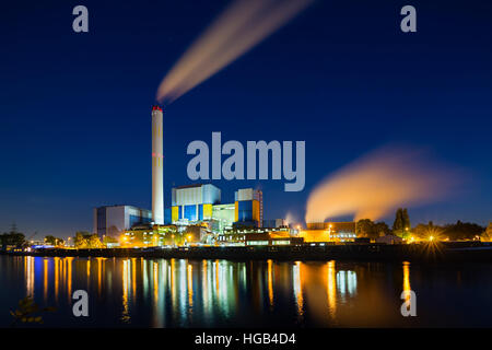 Colorful night view of a modern waste incineration plant in Oberhausen, Germany with deep blue sky. Stock Photo