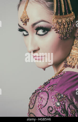 Serious Asian bride looking over shoulder Stock Photo