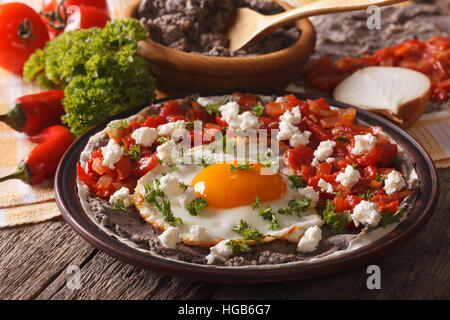 Mexican food: huevos rancheros close-up on a plate on the table. Horizontal Stock Photo