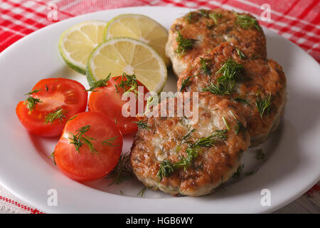 Cutlets from white fish fillets with herbs close-up on a white plate. horizontal Stock Photo