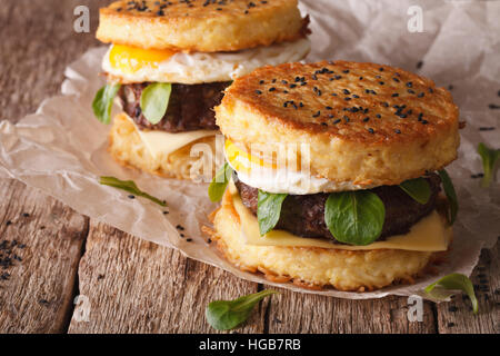 New fast food: ramen burger close-up on a paper on the wooden table. horizontal Stock Photo