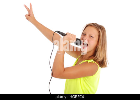 Happy young beautiful girl singing with microphone isolated on white background Stock Photo