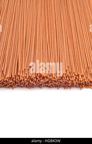raw whole grain spaghetti pasta studio isolated, vertical orientation Stock Photo