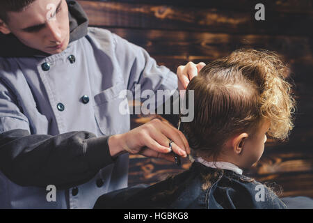 Little Boy Getting Haircut By Barber Stock Photo