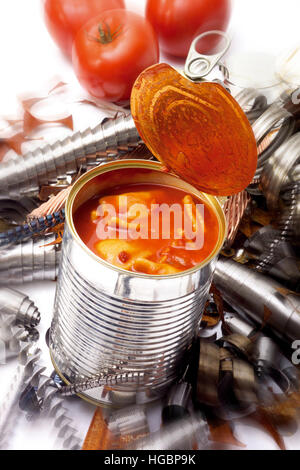 Symbol for recycling: can of ravioli, scrap metal in background Stock Photo