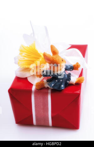 Easter gifts decorated with daffodil and little Easter bunny Stock Photo