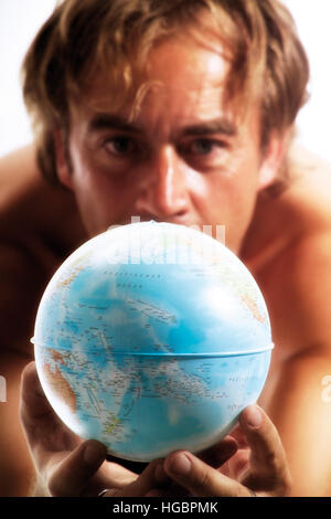 Man holding a globe Stock Photo