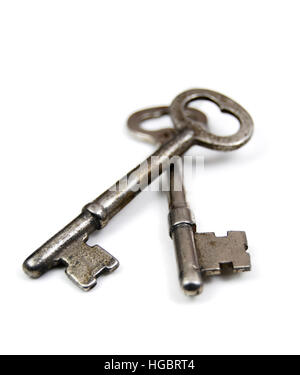Two old fashioned skeleton keys on a white background. Unlock new doors. Stock Photo