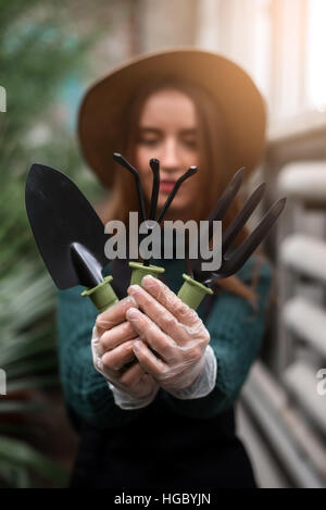 Gardener with garden tools in hands. Stock Photo