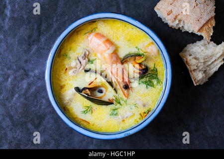 Scandinavian creamy fish soup with halibut, prawns and mussels Stock Photo
