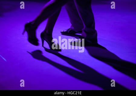 Tango dancers in milonga ballroom, detail of shoes. Stock Photo