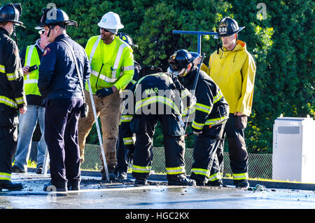 A fire hydrant broken off by a truck creates a geyser and small flood in San Leandro California Stock Photo