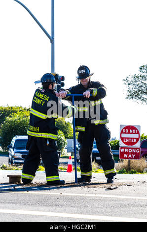 A fire hydrant broken off by a truck creates a geyser and small flood in San Leandro California Stock Photo