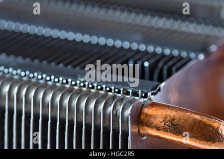 Aluminum radiator with copper heat pipe close-up with beautiful bokeh Stock Photo