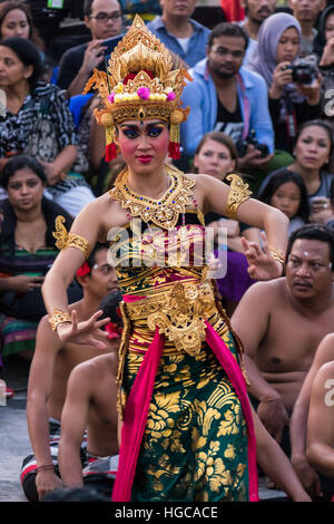 Balinese woman performing the traditional Kecak fire dance at Uluwatu Temple Bali. Stock Photo