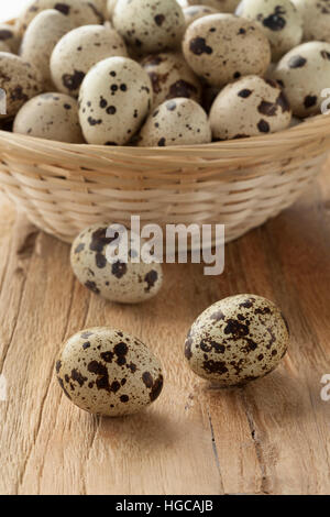 Basket with fresh raw Quail eggs Stock Photo