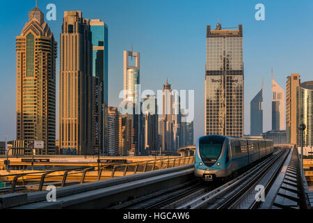 Dubai metro train with city skyline behind, Dubai, United Arab Emirates Stock Photo