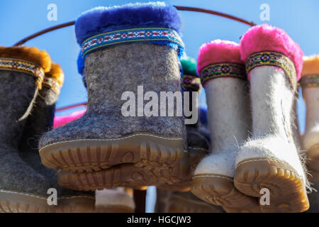 Children's winter shoes made of felt (felt boots) for walking in cold seasons. Sold at the fair. Stock Photo