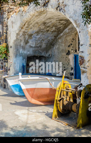 Traditional Greek fishing boats in Ormos harbour, Fira Santorini old port. Stock Photo