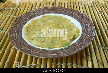Akki rotti -  Spicy Indian  traditional breakfast dish,made from rice flour, carrot and coconut. Stock Photo