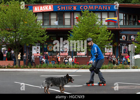 Downtown. Skating with a dog in the streets of Juneau. S Franklin street. Alaska Shirt Company. Alaska, USA.  The City and Borough of Juneau is the ca Stock Photo