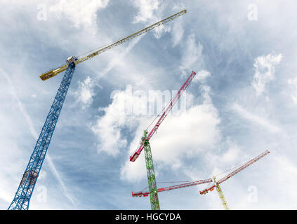 Construction site with three brightly colored cranes in London Docklands Stock Photo