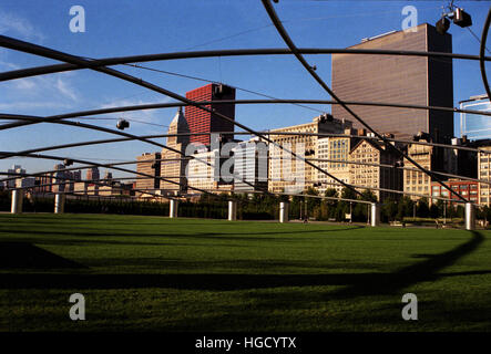 The stainless steel trellis hovers over the lawn at the Jay Pritzker Pavilion in Chicago's Millennium Park. Stock Photo