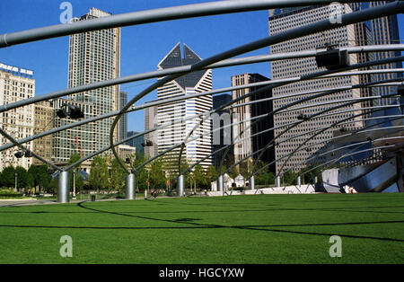 The stainless steel trellis hovers over the lawn at the Jay Pritzker Pavilion in Chicago's Millennium Park. Stock Photo