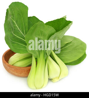 Organic Bok Choy in a wooden bowl over white background Stock Photo